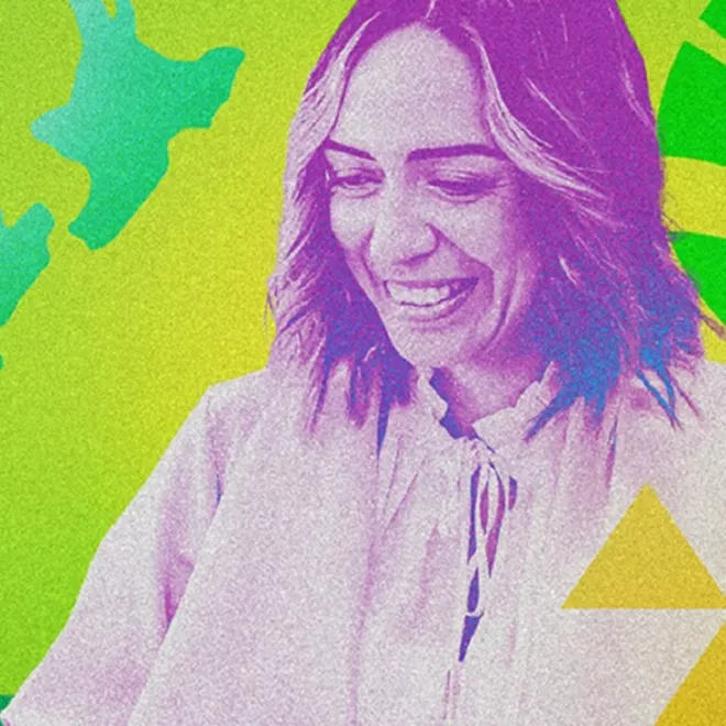 Close-up of woman smiling infront of multi-coloured background